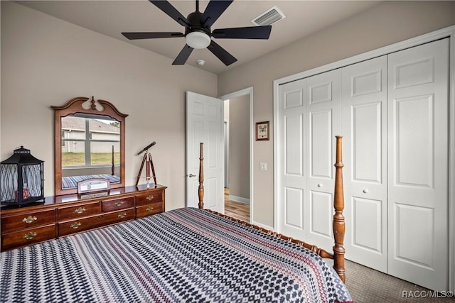 carpeted bedroom with ceiling fan and a closet