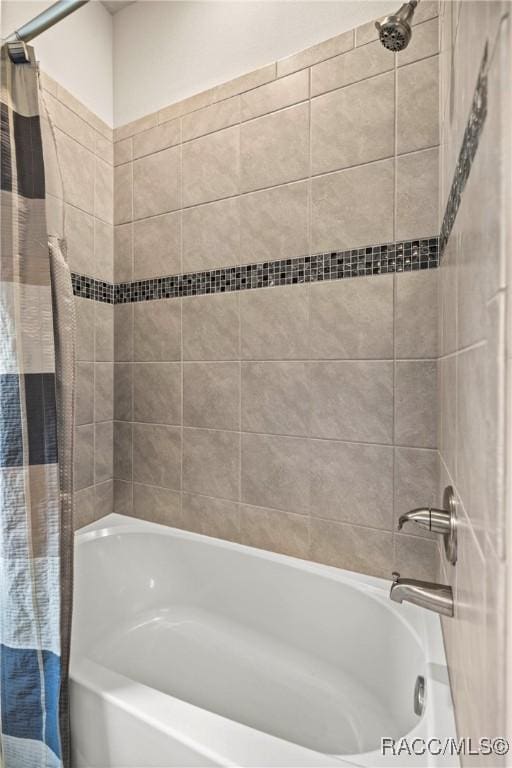 bathroom featuring shower / bath combo with shower curtain