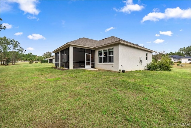 back of house with a sunroom and a yard