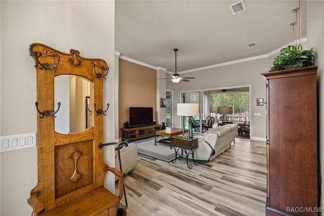 living room featuring ceiling fan, ornamental molding, and light hardwood / wood-style flooring