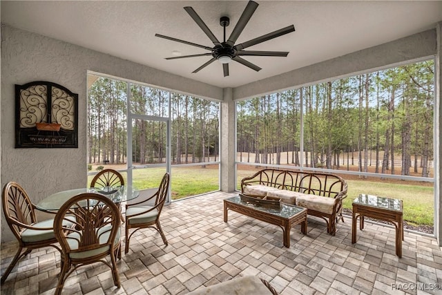 sunroom with a wealth of natural light and ceiling fan