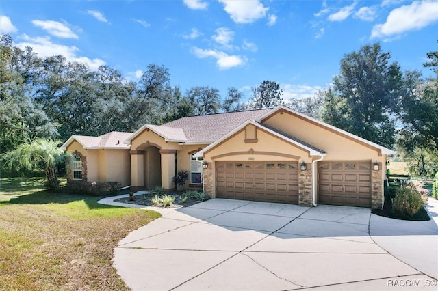 ranch-style house with a garage and a front lawn