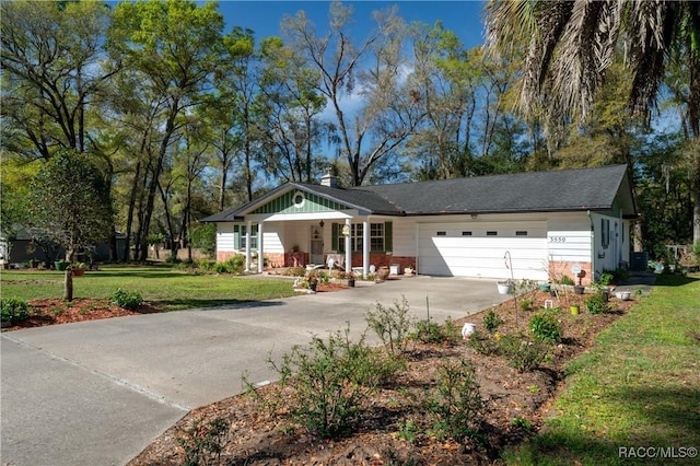 ranch-style house with driveway, a front yard, and a garage