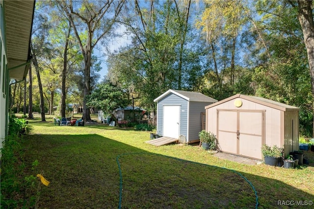 view of yard featuring an outbuilding and a shed