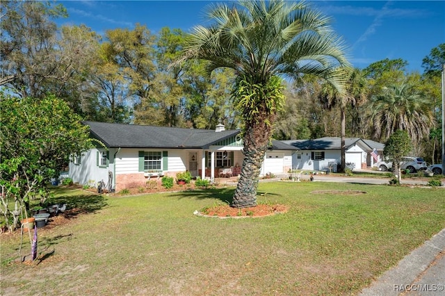 single story home featuring a garage and a front yard