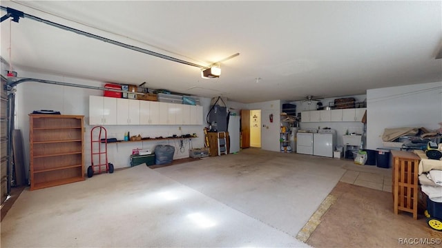 garage with a sink, separate washer and dryer, refrigerator, and a garage door opener