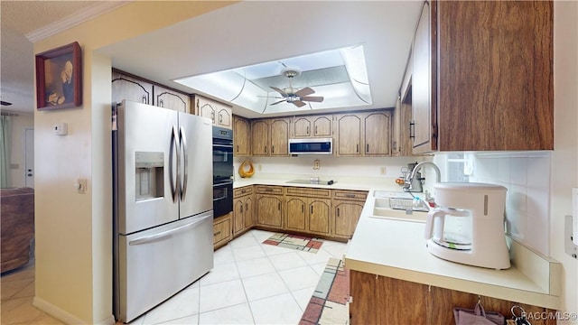 kitchen featuring ceiling fan, light countertops, light tile patterned floors, black appliances, and a raised ceiling