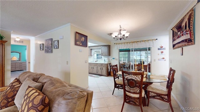 dining area featuring light tile patterned floors, visible vents, an inviting chandelier, ornamental molding, and a textured ceiling