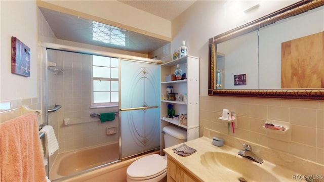 bathroom with toilet, tasteful backsplash, shower / bath combination with glass door, tile walls, and vanity