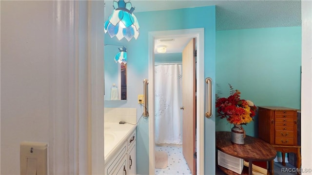 full bathroom featuring a shower with shower curtain, vanity, and tile patterned floors