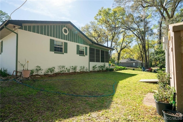 view of home's exterior featuring a lawn and stucco siding