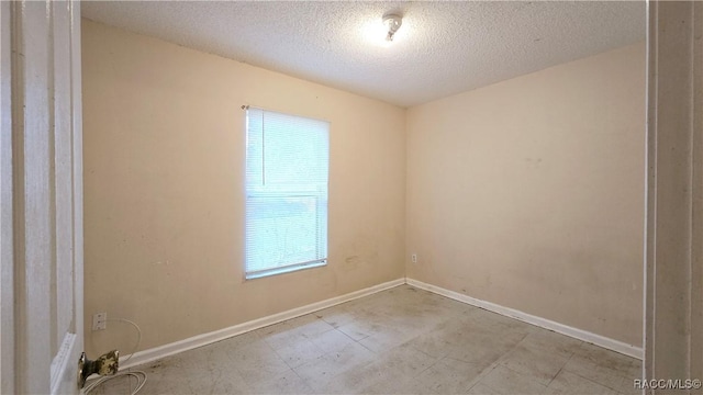 spare room featuring a textured ceiling