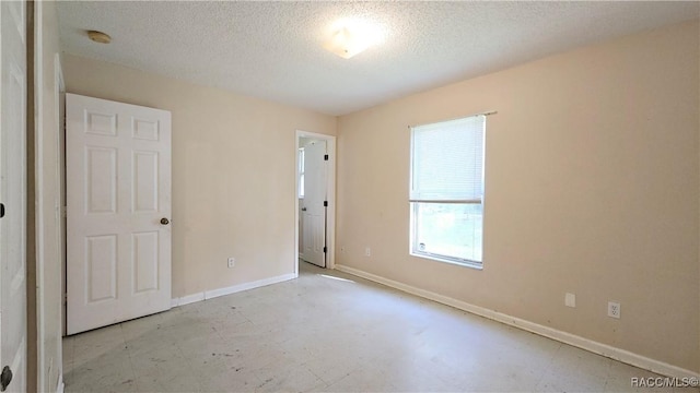 unfurnished bedroom featuring a textured ceiling