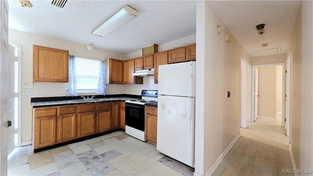 kitchen featuring a textured ceiling, white appliances, and sink