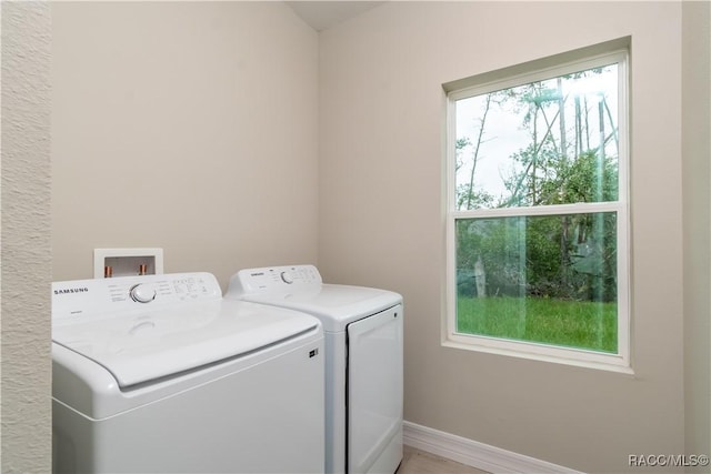 laundry area with a wealth of natural light and washing machine and clothes dryer