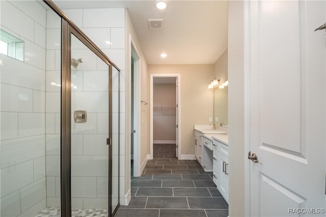 bathroom featuring vanity and an enclosed shower