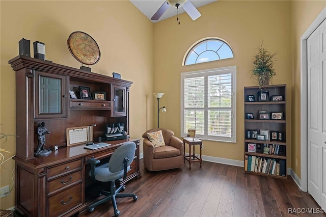 office with ceiling fan, dark hardwood / wood-style flooring, and a high ceiling