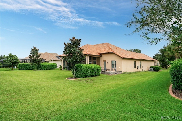 back of property featuring a lawn