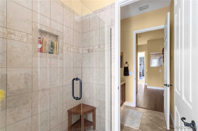 bathroom with hardwood / wood-style floors and a shower with door