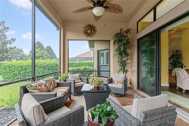 sunroom / solarium featuring ceiling fan