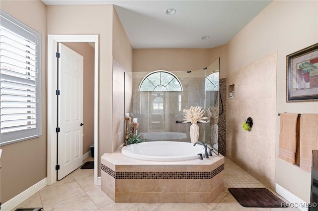 bathroom with separate shower and tub and tile patterned floors