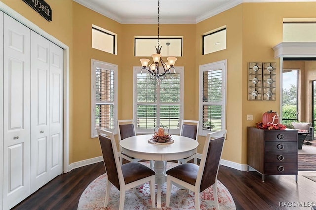 dining area with a notable chandelier, dark hardwood / wood-style floors, and ornamental molding