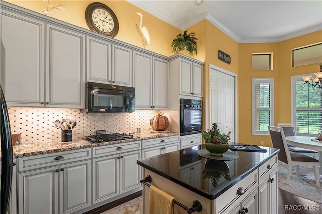 kitchen with backsplash, dark stone counters, crown molding, and black appliances