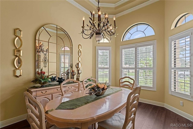 dining space with dark hardwood / wood-style floors, plenty of natural light, crown molding, and a chandelier