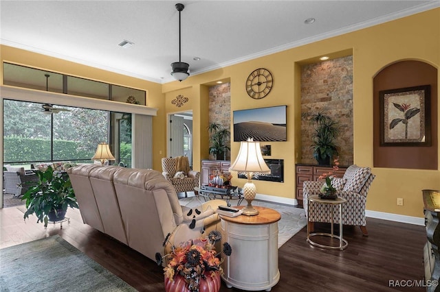 living room featuring crown molding, ceiling fan, and dark hardwood / wood-style floors