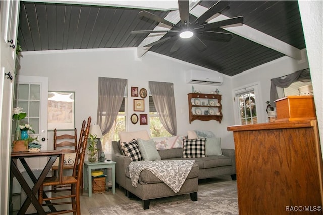 sitting room with lofted ceiling with beams, ceiling fan, a wall mounted air conditioner, and wood finished floors