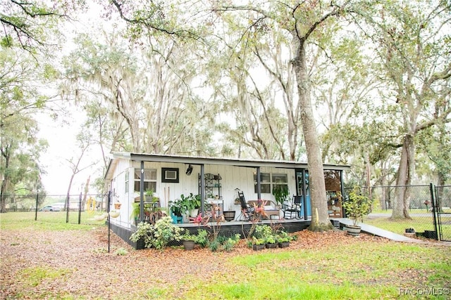 view of front of property with a front yard and fence