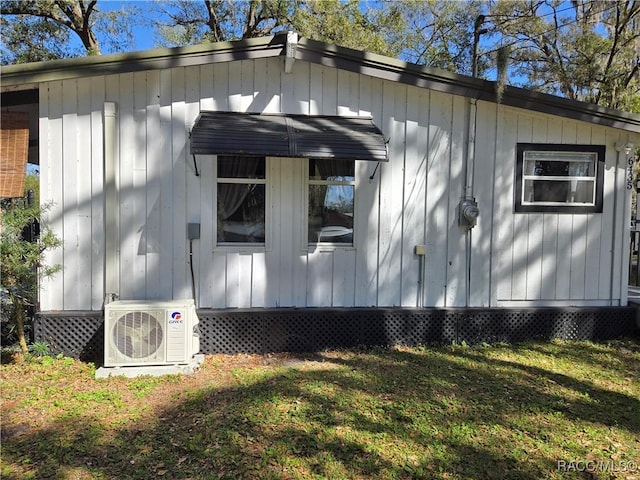 view of property exterior with ac unit and a yard