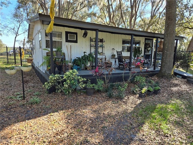 view of front of house with a deck and fence