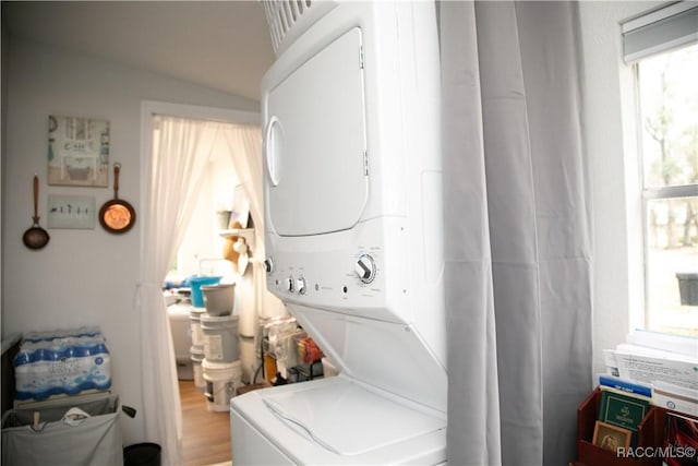 laundry area featuring stacked washer / dryer and laundry area