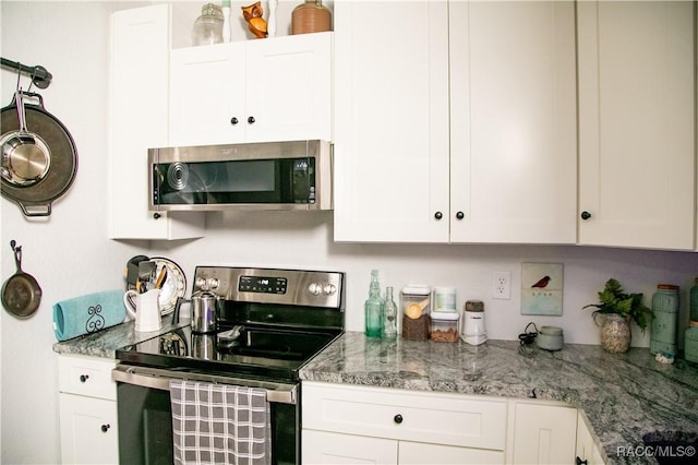 kitchen featuring white cabinetry, stainless steel appliances, and light stone counters