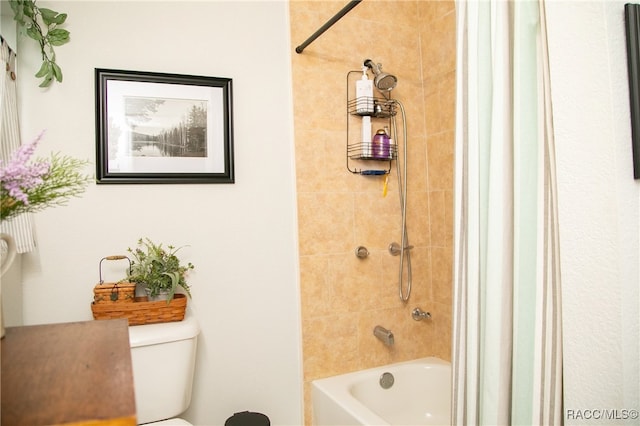 bathroom with bathtub / shower combination and toilet