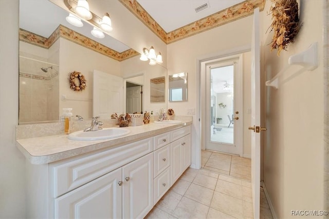 374 W Wason St, Citrus Springs, FL 34434 - bathroom featuring double vanity, tile patterned flooring, and a tile shower