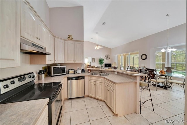 374 W Wason St, Citrus Springs, FL 34434 - kitchen featuring stainless steel appliances, a chandelier, under cabinet range hood, light tile patterned flooring, and a breakfast bar