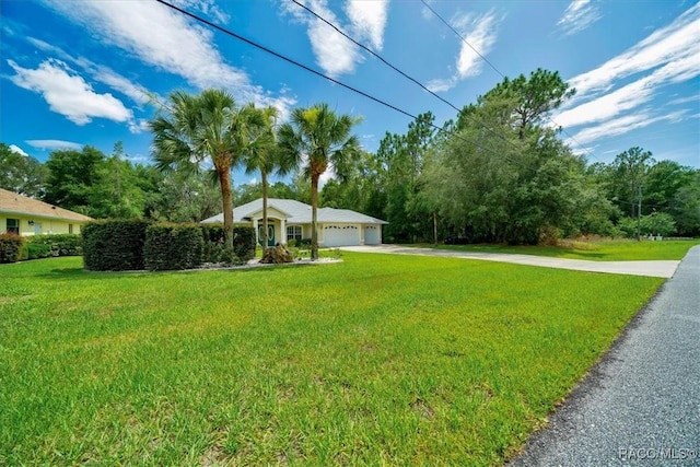 374 W Wason St, Citrus Springs, FL 34434 - view of front of house with driveway, a front yard, and a garage