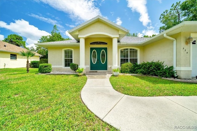 374 W Wason St, Citrus Springs, FL 34434 - property entrance featuring stucco siding and a lawn