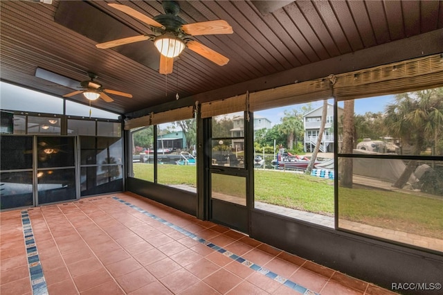 unfurnished sunroom with lofted ceiling and wood ceiling