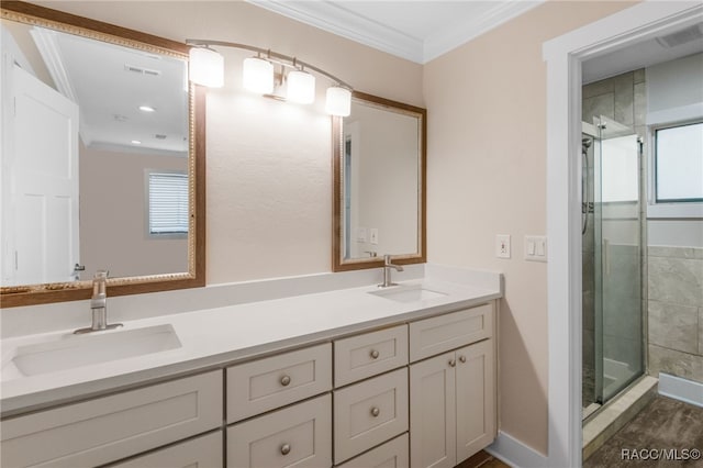 full bath featuring a sink, a stall shower, and ornamental molding