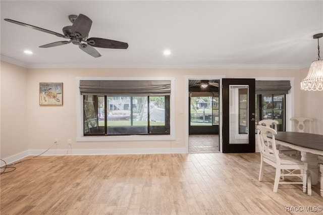 unfurnished living room with recessed lighting, baseboards, crown molding, and light wood-style floors