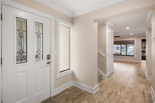 entryway with stairway, wood finished floors, baseboards, recessed lighting, and crown molding