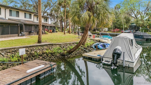 view of dock featuring a lawn