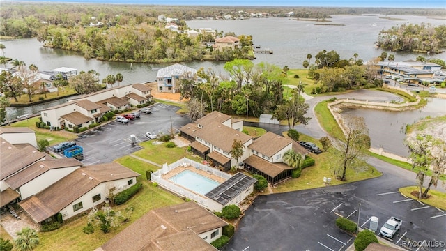 drone / aerial view featuring a water view and a residential view