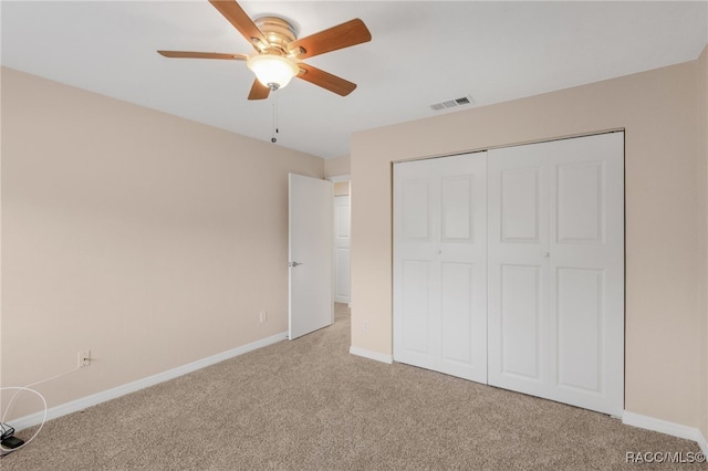 unfurnished bedroom with visible vents, light carpet, baseboards, and a closet