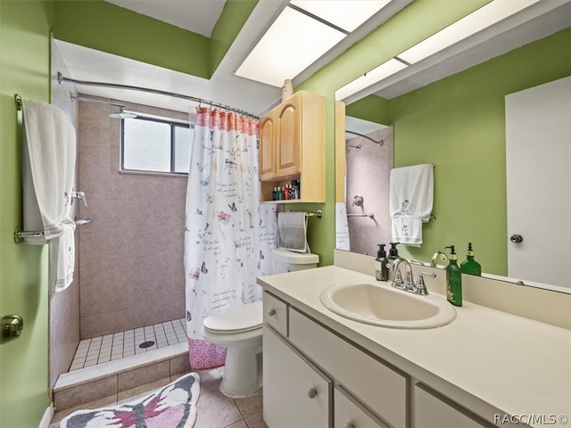 bathroom with toilet, tile patterned flooring, vanity, and walk in shower