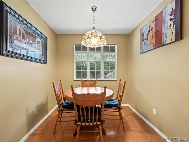 dining area with hardwood / wood-style floors