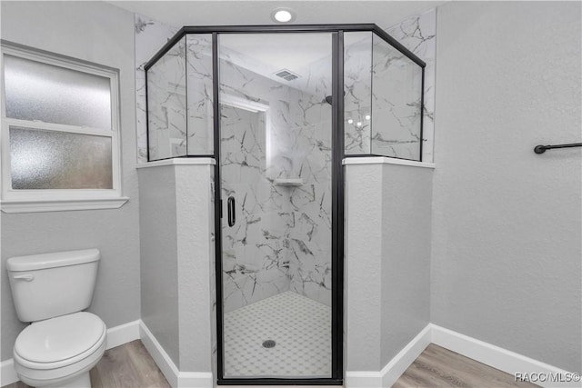 4065 SW 5th Ave, Ocala, FL 34471 - bathroom with hardwood / wood-style flooring, toilet, and an enclosed shower